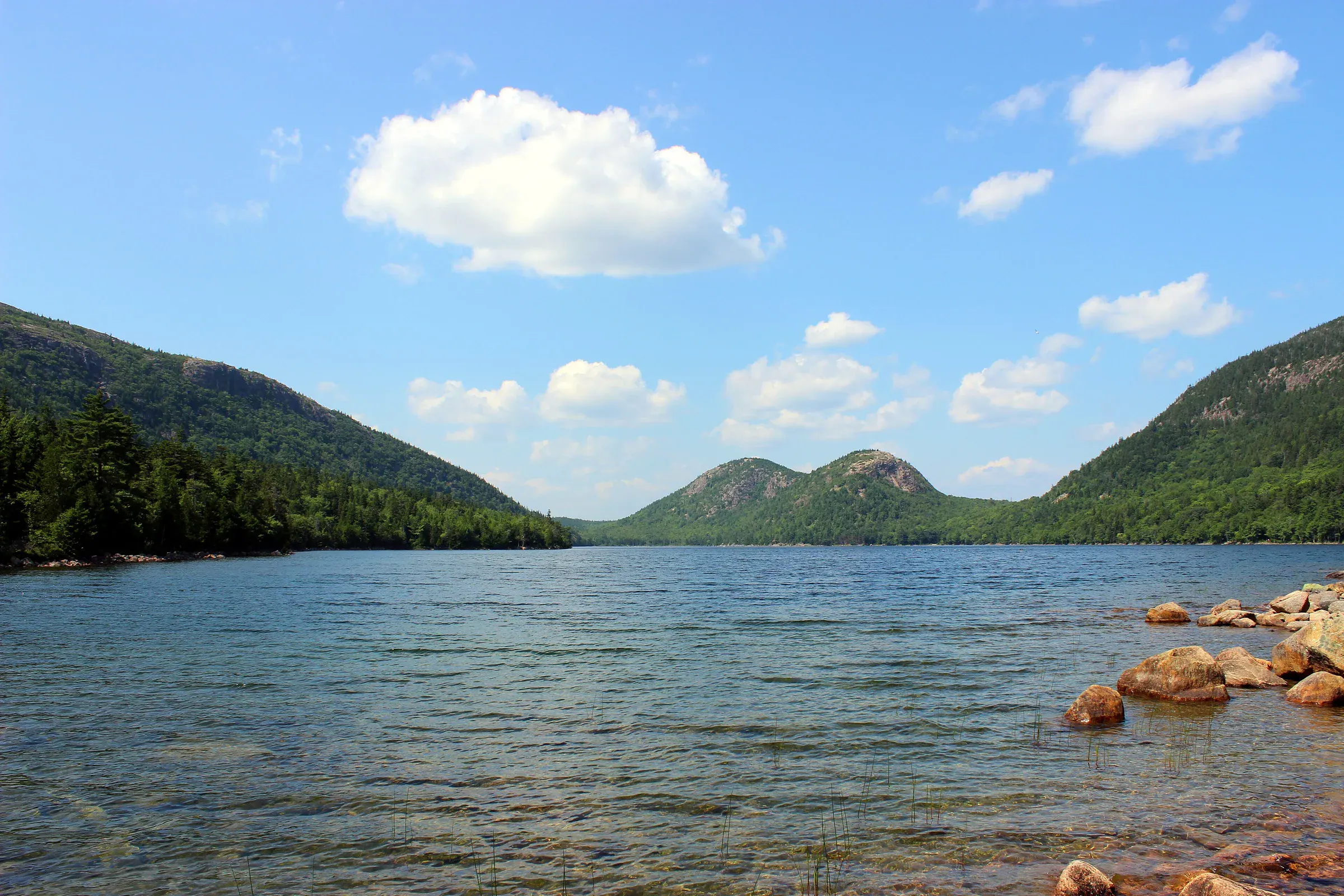 Jordan Pond beneath rounded mountains in Acadia National Park